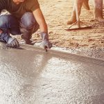 Plasterer screed concrete for floor in building